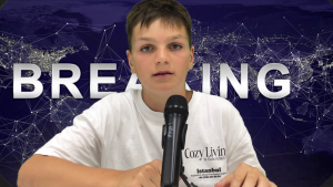 Jugendlicher sitzt vor einem Mikrofon vor einem Nachrichten-Hintergrund.