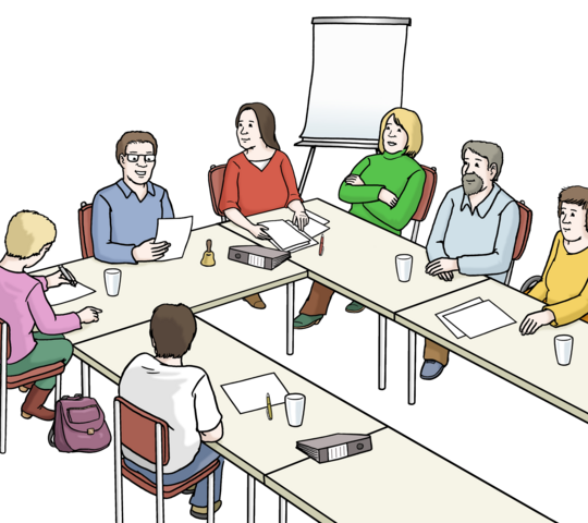 Verschiedene Menschen sitzen an einem U-förmigen Tisch und halten ein seminar ab